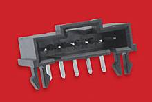 A black connector with six metal pins on a red background. Vertical orientation of the pins for electronic applications.