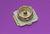 A single coaxial connector on a purple background.
