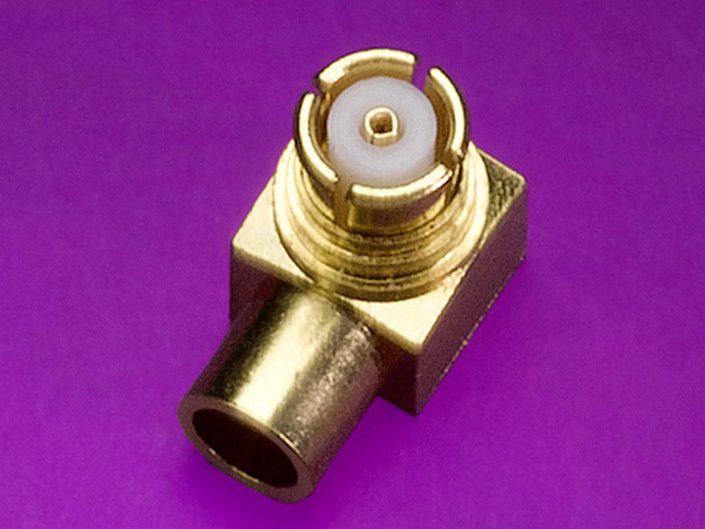 Golden HF connector on a purple background. The connector has a rectangular housing and a central opening for electrical connections.