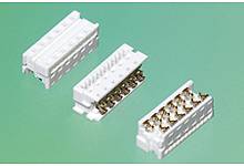 Three white electrical connectors on a green background, shown from different angles. Ideal for electronic applications.