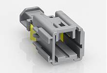 Grey plastic plug with a rectangular shape and yellow internal components, lying on a white background.