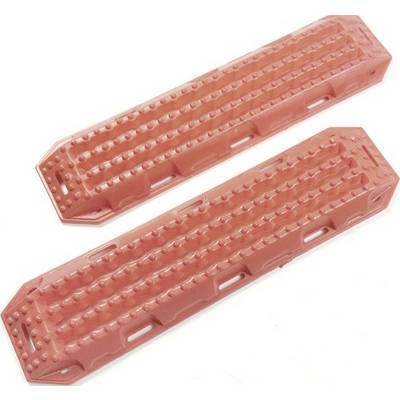 Two red sand tracks with non-slip studs, used to increase the traction of vehicle tyres in sandy or muddy terrain.