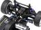RC suspension from a bird's eye view, showing the front suspension system with blue shock absorbers and control arms.