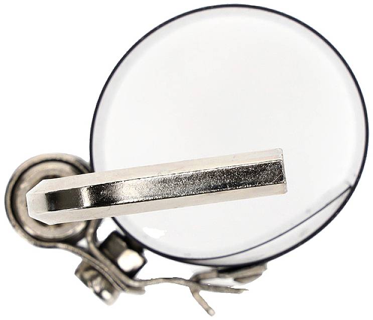 A silver spectacle frame in close-up, positioned on top of a round, transparent lens. Clean lines and minimalist design.