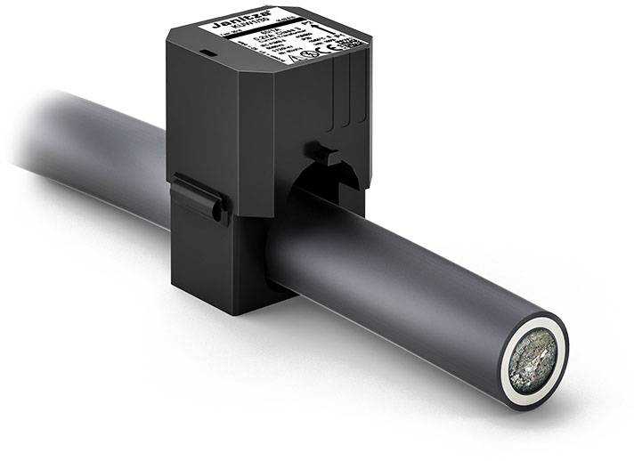 A black electronic sensor encircling a cable. Technical information and labels are visible on the top of the sensor.