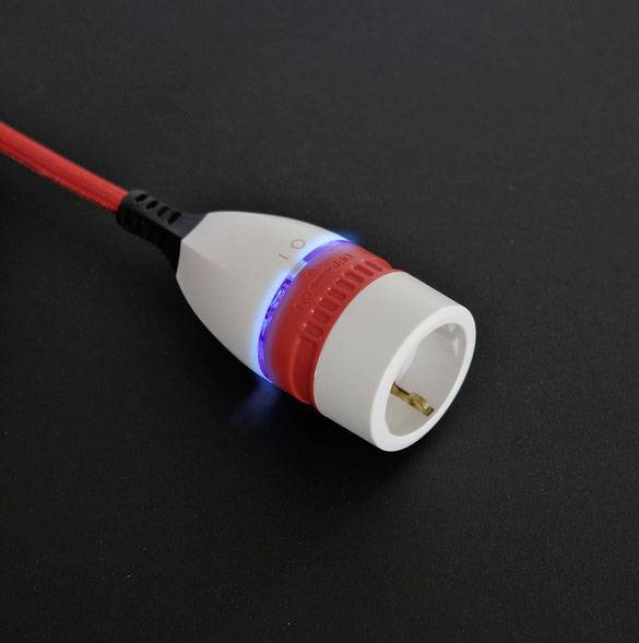A European plug adapter with a red cable and a glowing blue indicator on a black background.