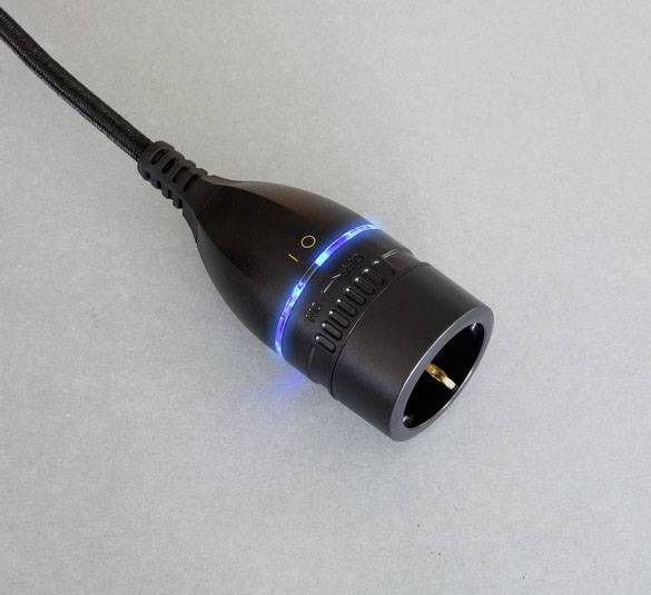'Black connector with blue illuminated ring on a grey background.'