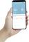 A hand is holding a smartphone displaying an app for temperature and humidity monitoring. Temperature 26.4 °C, humidity 55%.