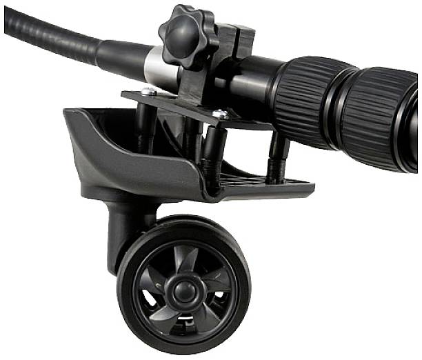 Close-up of a black tripod wheel attached to a tripod leg. It enables easy movement of the tripod.
