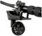 Close-up of a black tripod wheel attached to a tripod leg. It enables easy movement of the tripod.