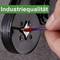 'Industrial Quality': Hand placing a wire into a device used for measurement or fastening, against a grey background.