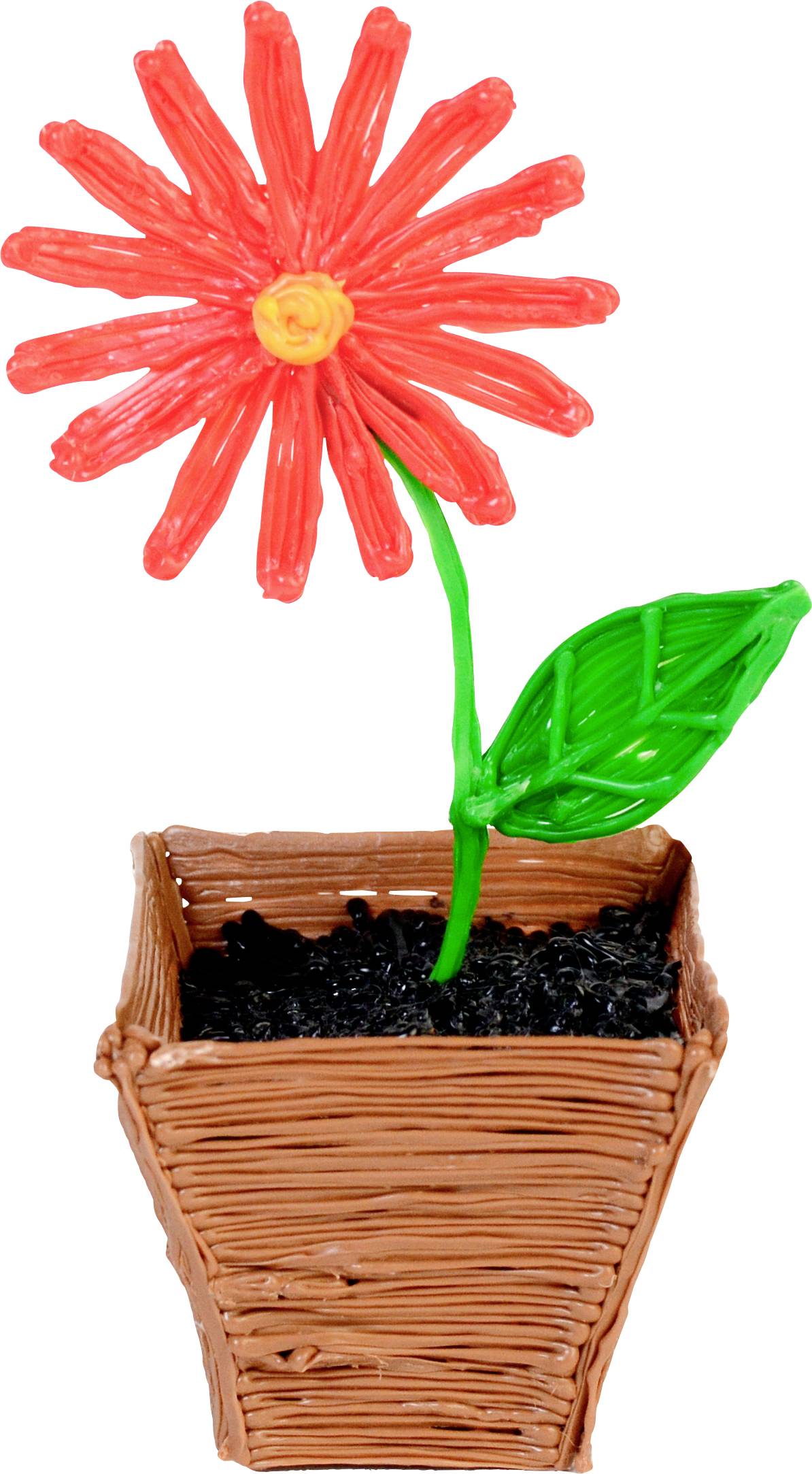 Artificial flower made from red and yellow plasticine with a green stem and leaf in a brown, textured plant pot with black granules.