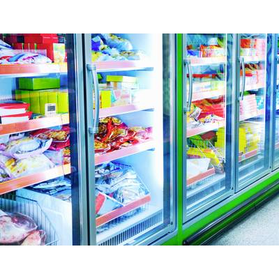 Refrigerated section with various frozen foods such as pizza, vegetables, and meat in a supermarket.