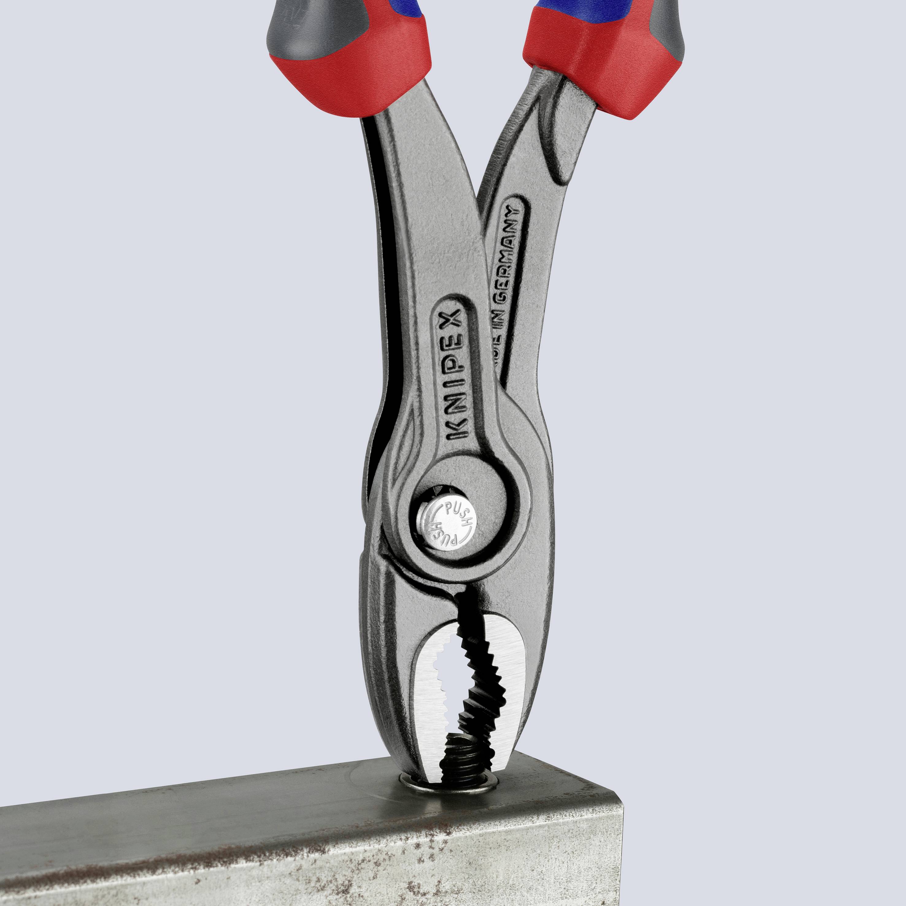 A pair of pliers grips a metal part. The pliers have red and blue handles.