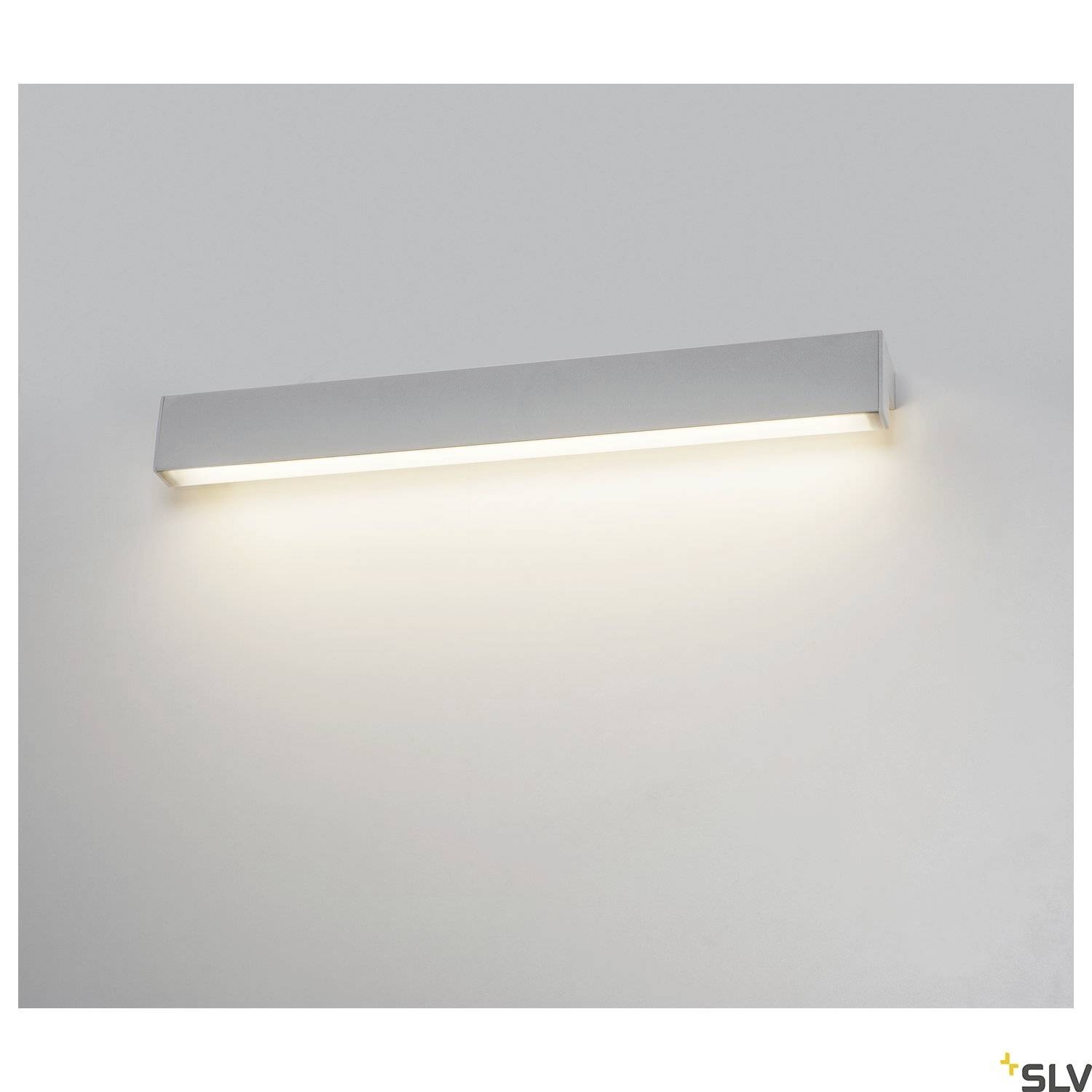 A simple, rectangular wall light with an aluminium finish, which radiates even, warm white light downwards.