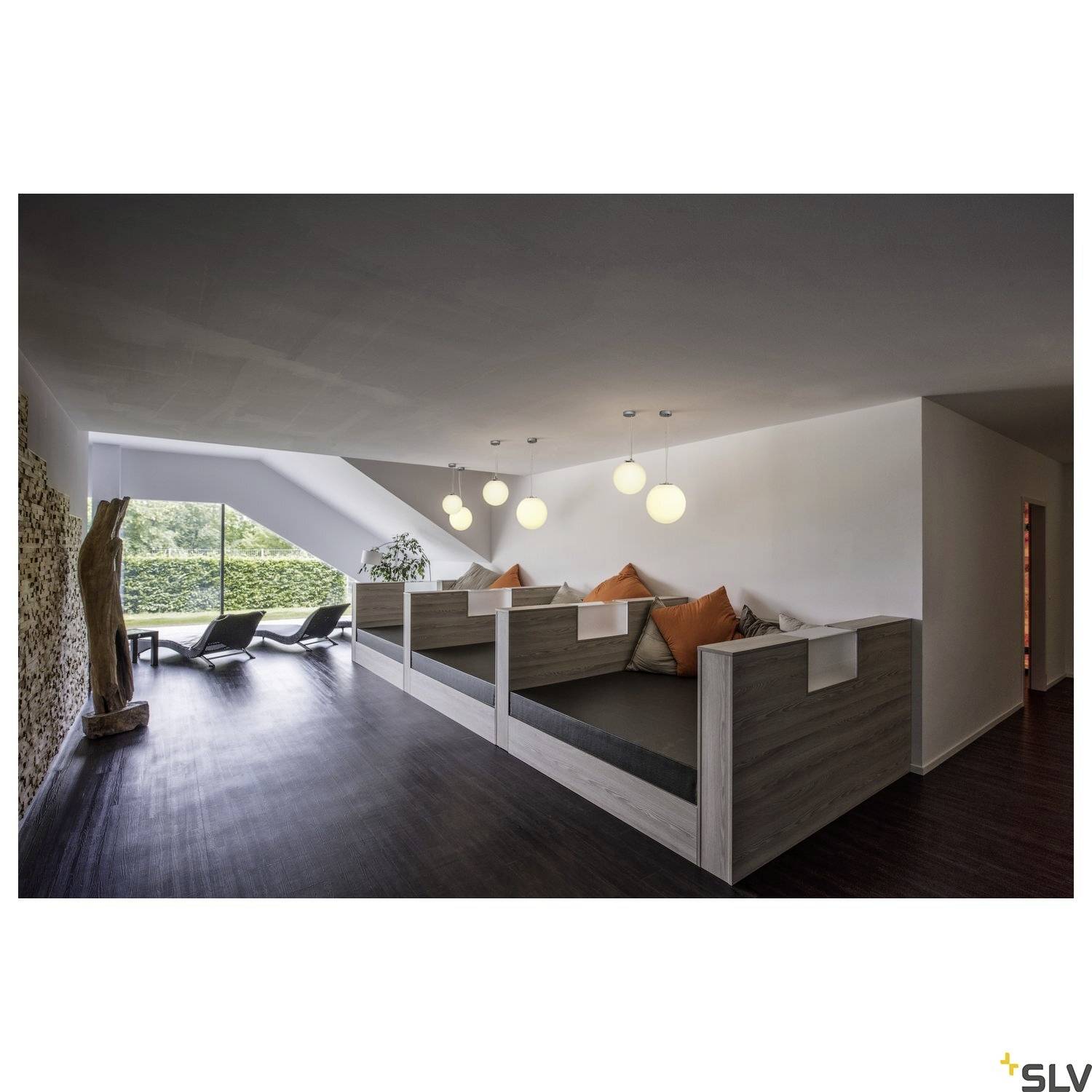 'Modern living area with large windows, reclining spaces and stylish pendant lights that flood the space with natural light.'