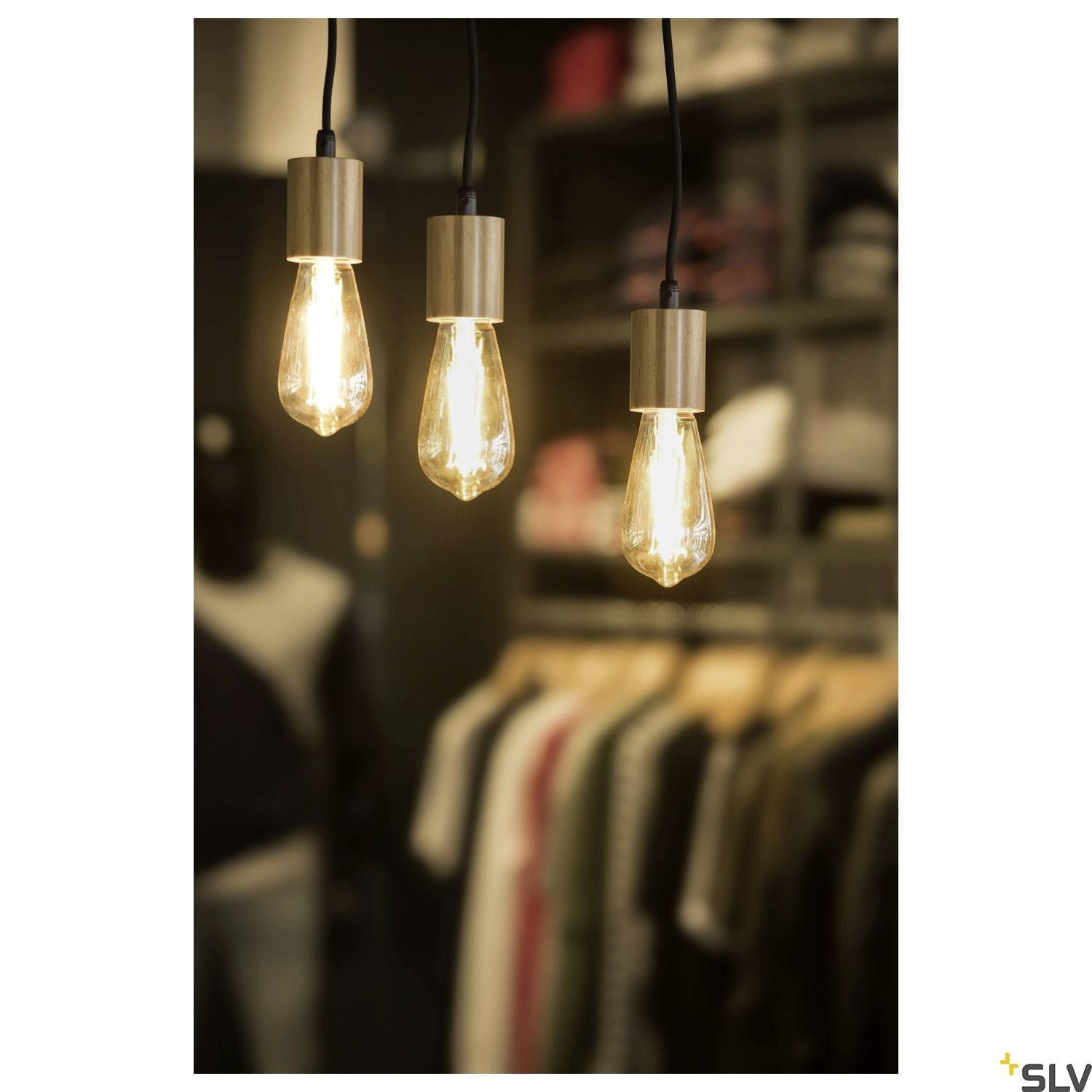 Three hanging light bulbs glow warmly over a blurred background of clothing, creating a cosy atmosphere.