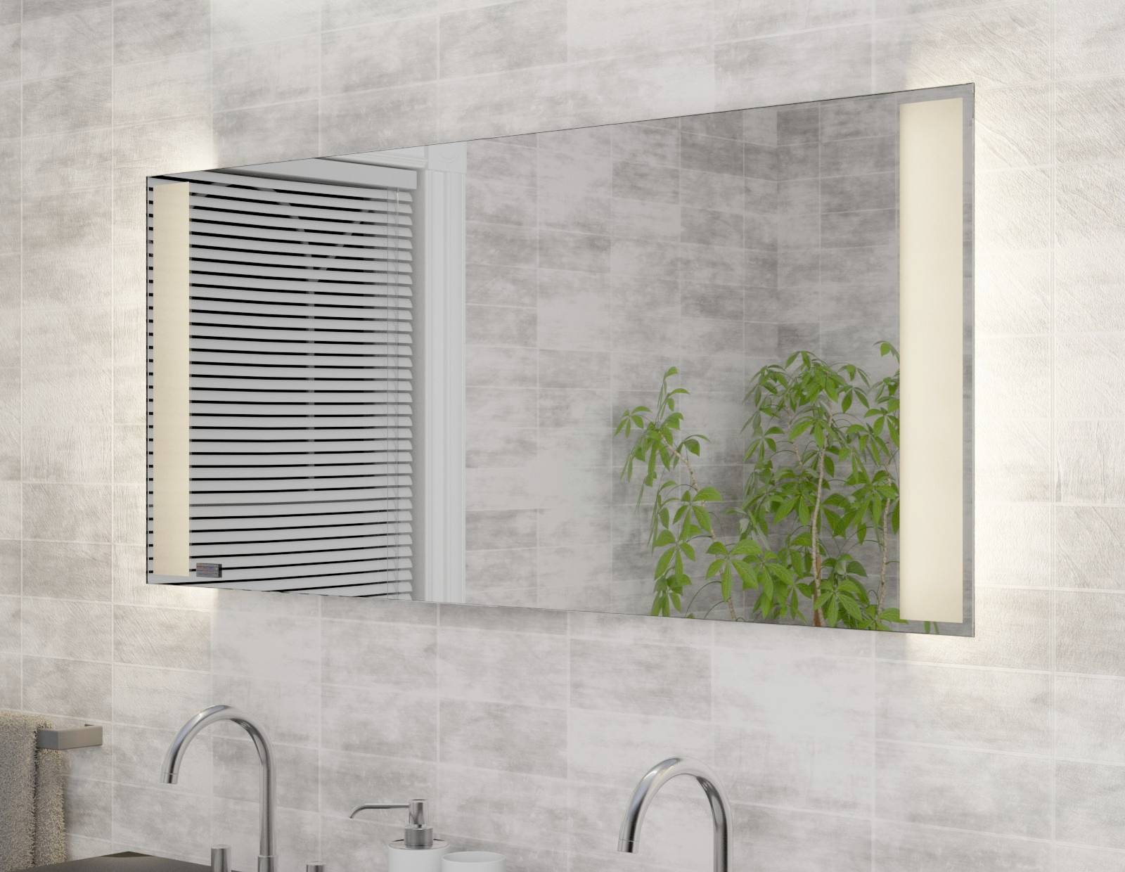 A modern bathroom wall mirror with lighting, reflecting a washbasin and a plant. Tiled wall in the background.