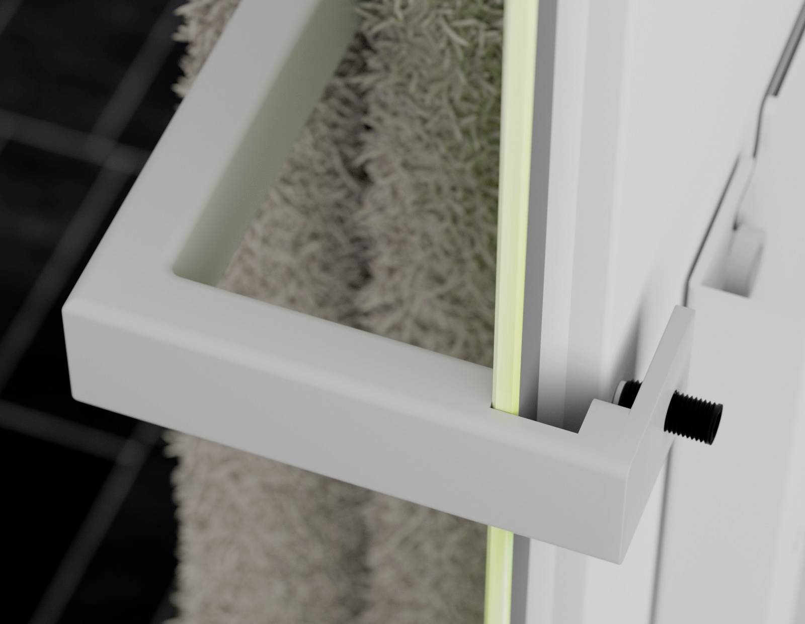 A white towel rail is attached to a door. A grey towel hangs on the inside.