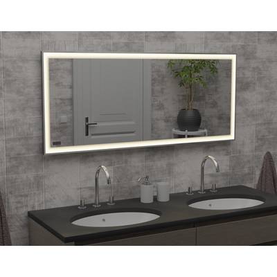 A lit mirror above a double basin, mounted on a tiled wall in a modern bathroom, with a plant in the background.