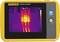 A portable thermal imaging device shows a temperature measurement of 30.7 °C. The display shows a coloured thermal image.