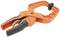 Orange plastic clamp with bolt lock and black rubber-coated handles, used for holding objects.
