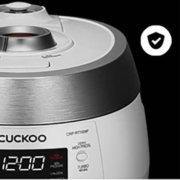 A white rice cooker with a digital display on a black background. A tick symbol is located in the top right corner.