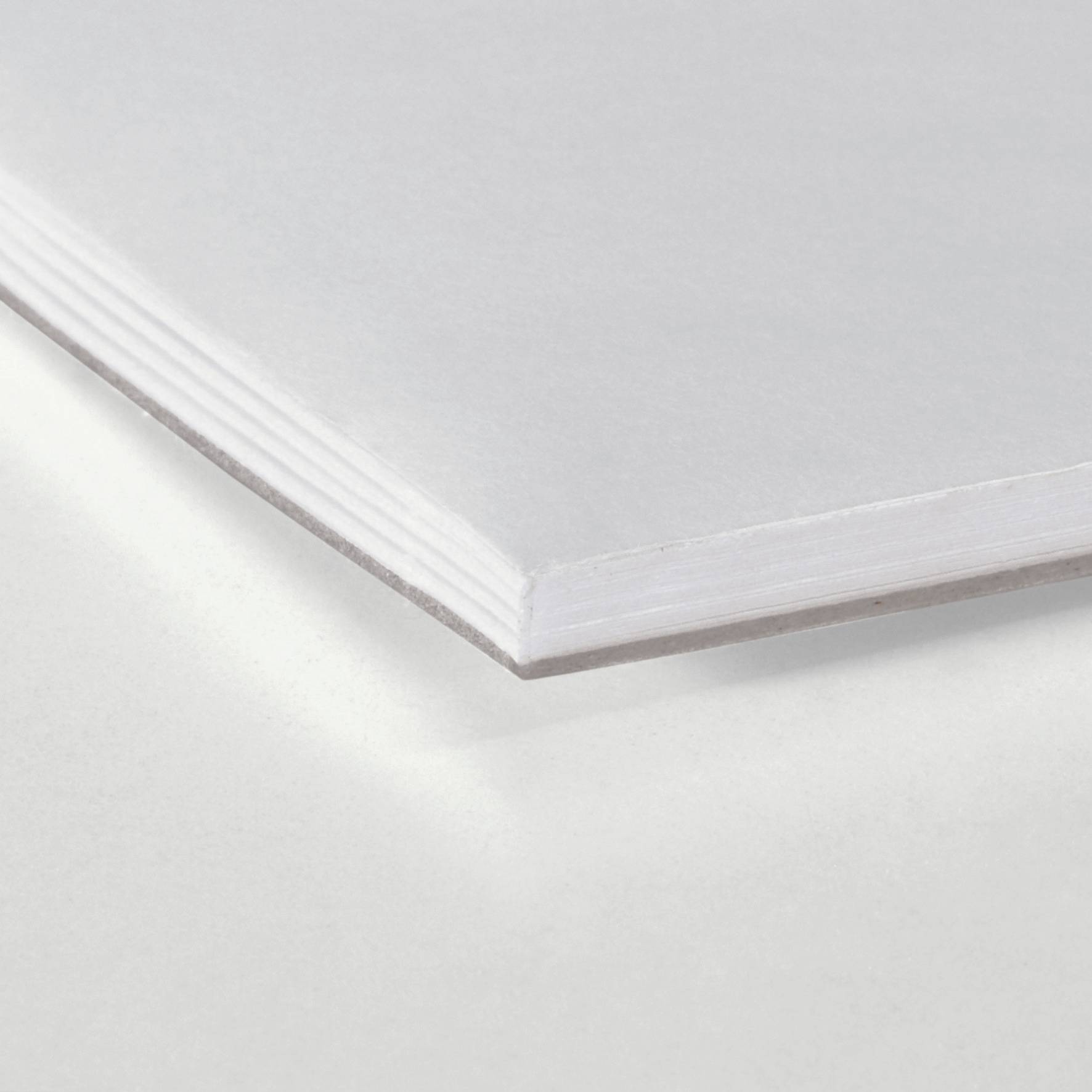 A stack of white paper viewed from the side, showing its thickness and smooth surface. Suitable for printing or writing purposes.