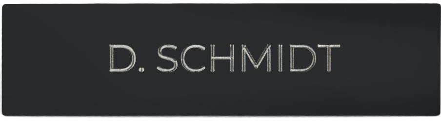 Name badge with the inscription 'D. Schmidt'. Black background, white text.