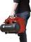 A person is carrying a red Toolcraft cordless compressor without cables or hoses, suitable for portable use.