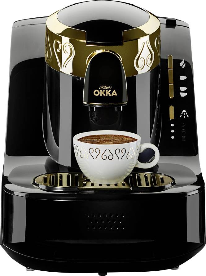 Black coffee machine with golden accents, brewing a cup of espresso. Cup sits on the machine's drip tray.