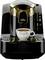Black coffee machine with golden accents, brewing a cup of espresso. Cup sits on the machine's drip tray.