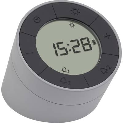 A cylindrical digital clock with a large display shows the time '15:28'. Alarm and battery status symbols are visible.