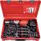 Open red toolbox with drill, charger and accessory parts, organised in matching compartments, marked with 'ROTHENBERGER'.