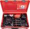 Red tool case with all accessories for a cordless pressing tool. Includes the pressing tool, chargers, and various pressing jaws.