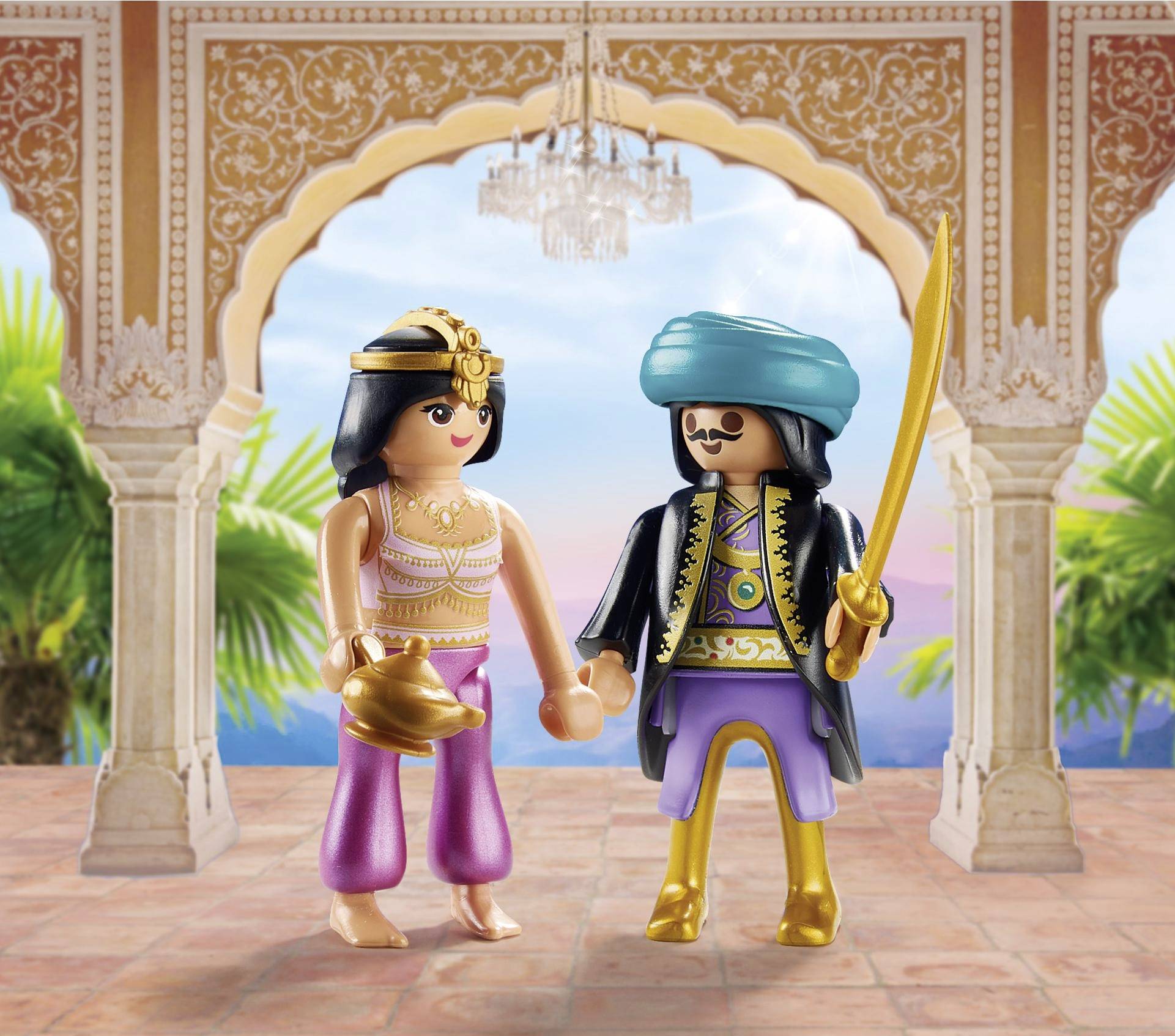 Two figurines in oriental costumes stand in a palace with golden ornamentations. The background shows palm trees and a blue sky.