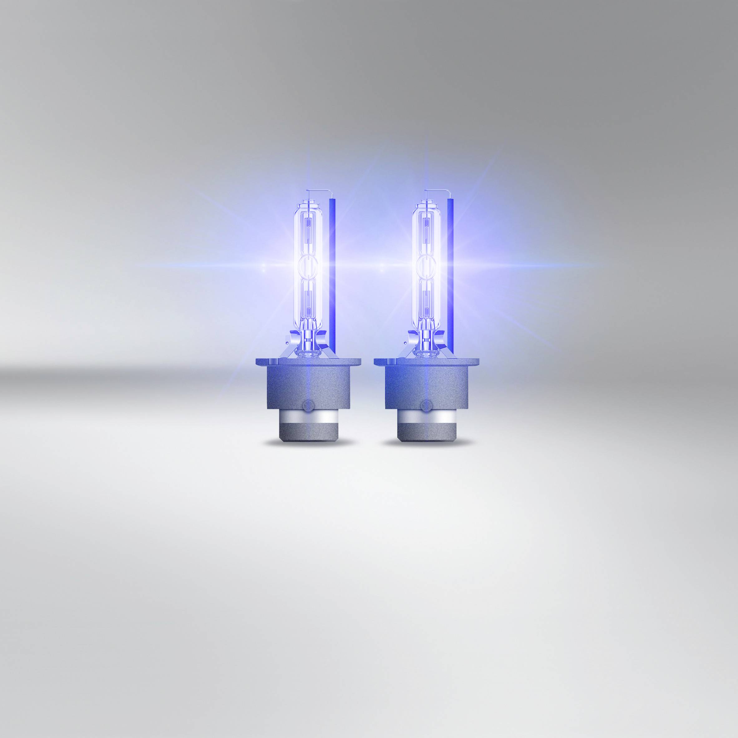 Two illuminating car lamps on a grey background, emitting blue light. They represent a replacement light source for vehicles.