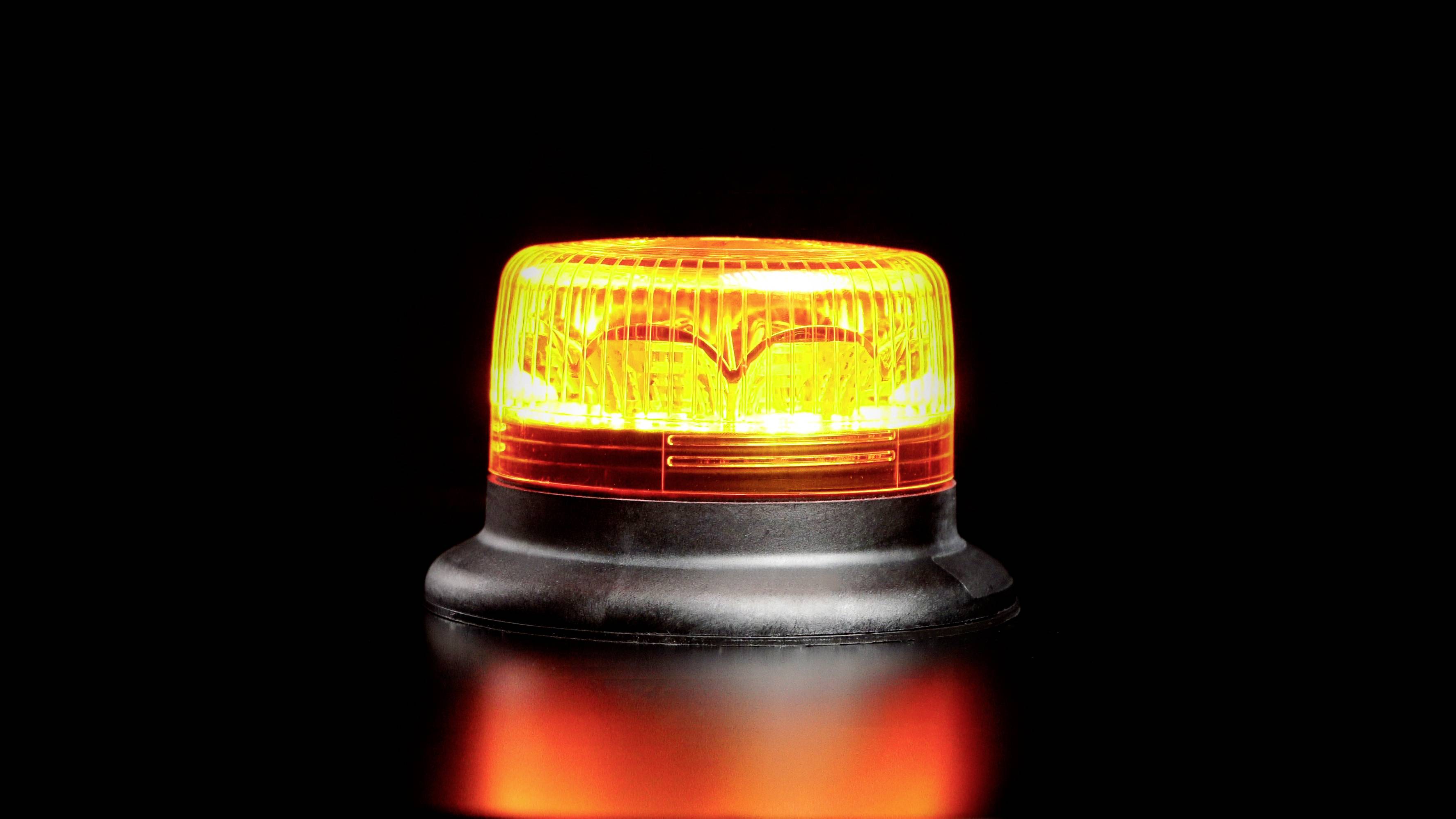 Orange warning light on a black background.<br><br>Note: While this is a direct translation, in British English the term "warning light" is perfectly acceptable and commonly used.