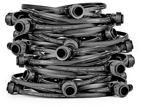 Several coiled black cables with plugs; potential use in electronics or construction.