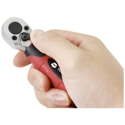 A hand is holding a small ratchet spanner with a red and black handle.