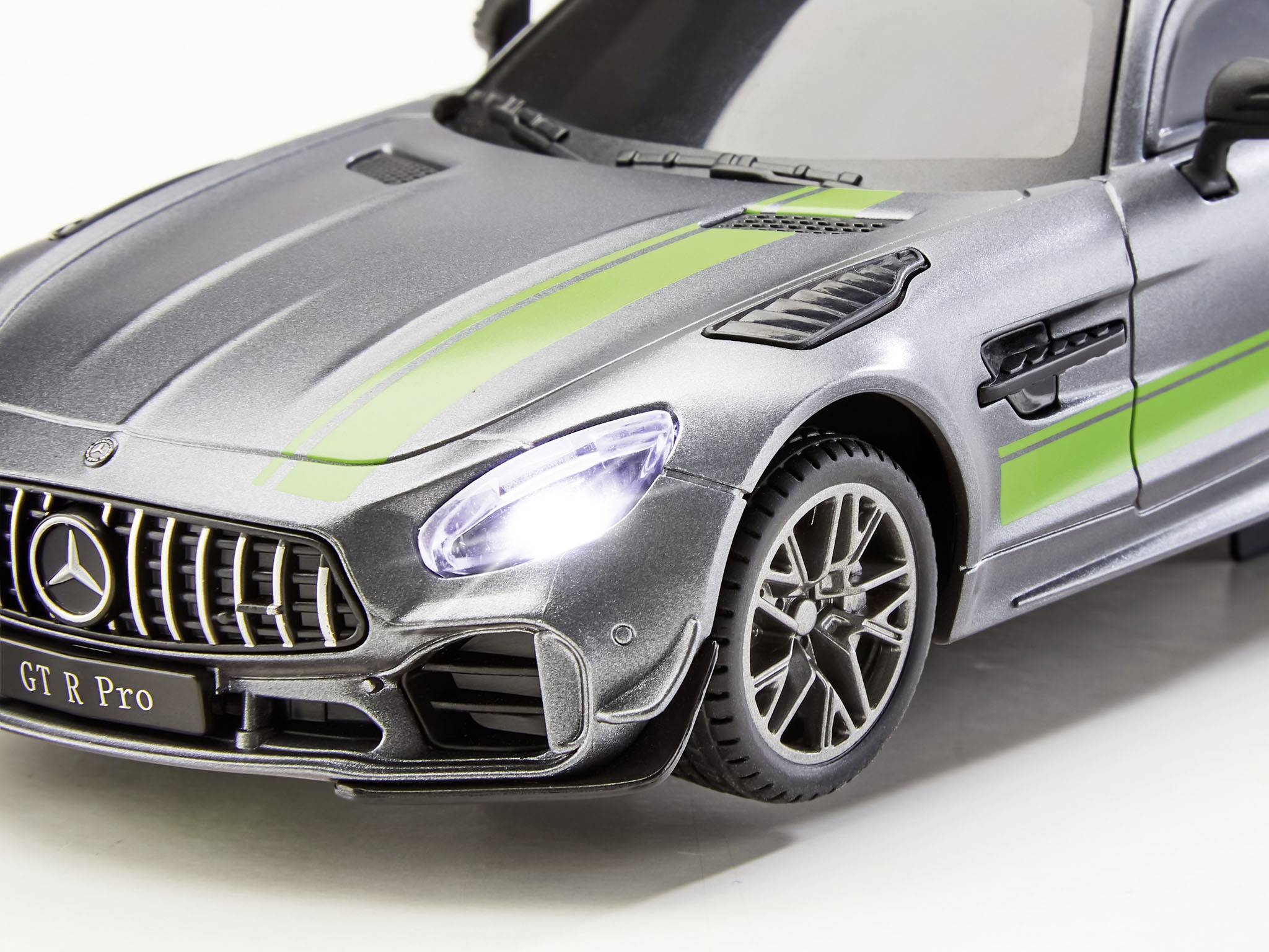 Grey model car of a sports car with green stripes, visible details on the front and wheels, showcasing luxury and performance.