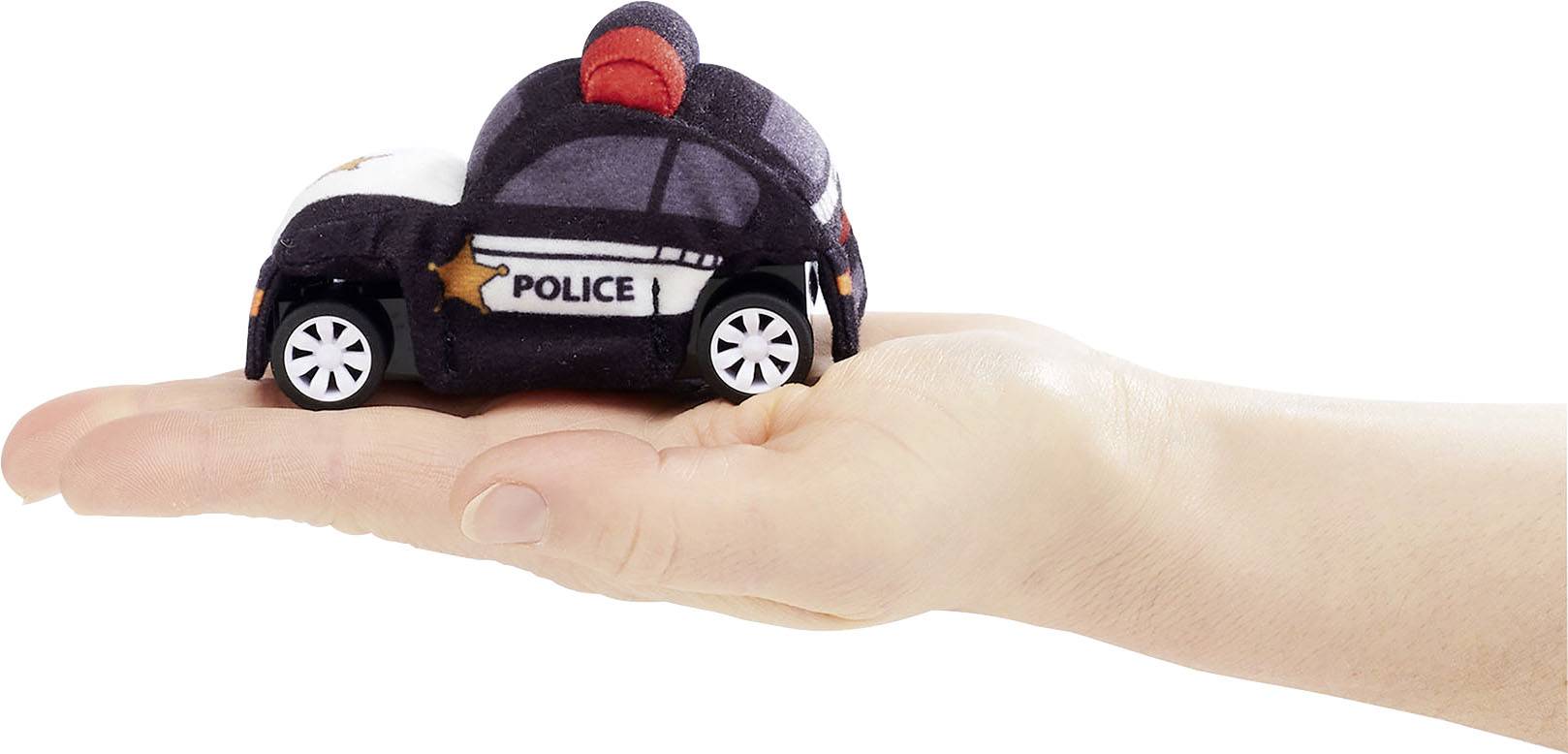 A hand is holding a small toy car, designed like a police car, in its palm.