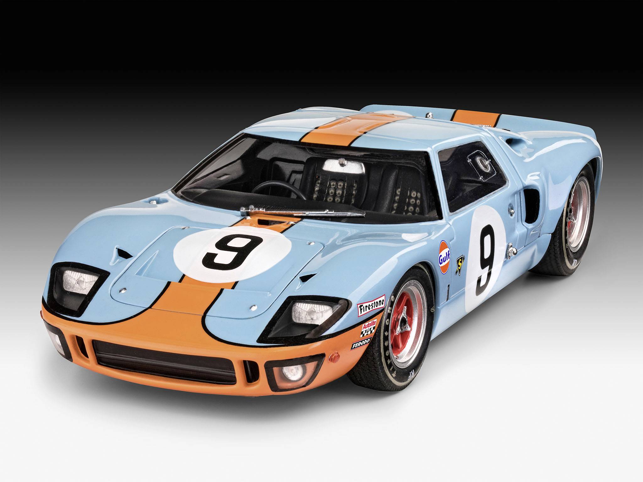 Classic racing car, blue with orange stripes, displaying race number 9 on the bonnet and door. 1970s design.