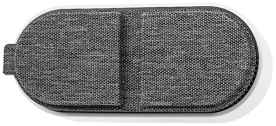 A grey, fabric-covered, oval case rests on a white surface.