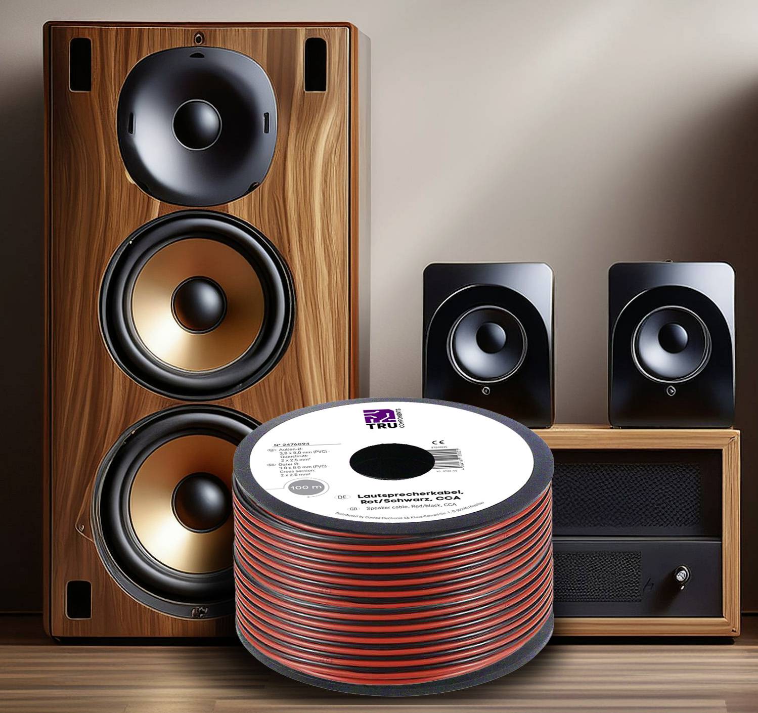 'Speaker setup with large wooden cabinet speakers, two black satellite speakers, and a coil of speaker cable.'