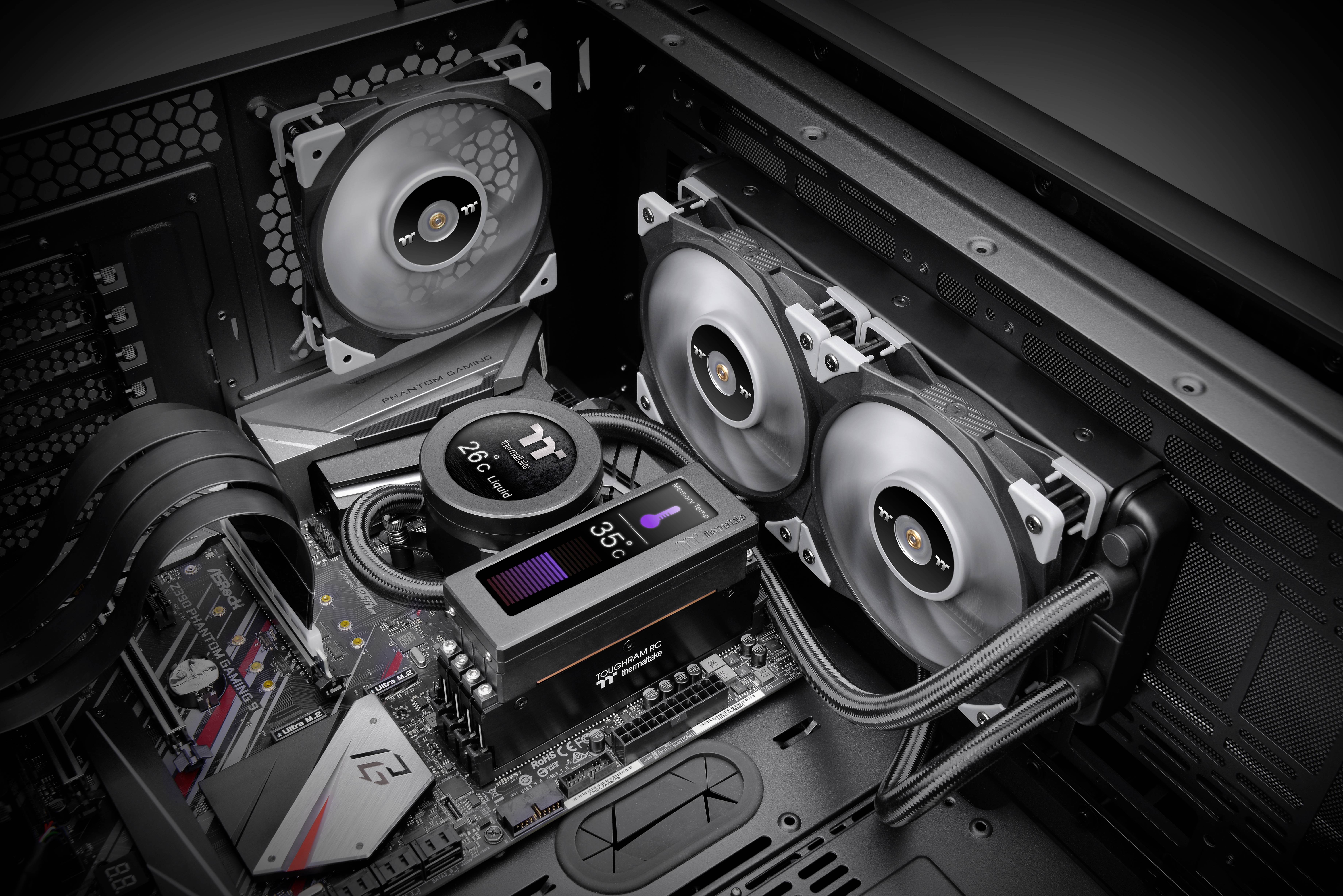 Computer case with PC components: an open cover reveals fans, a central unit with temperature display and wiring.