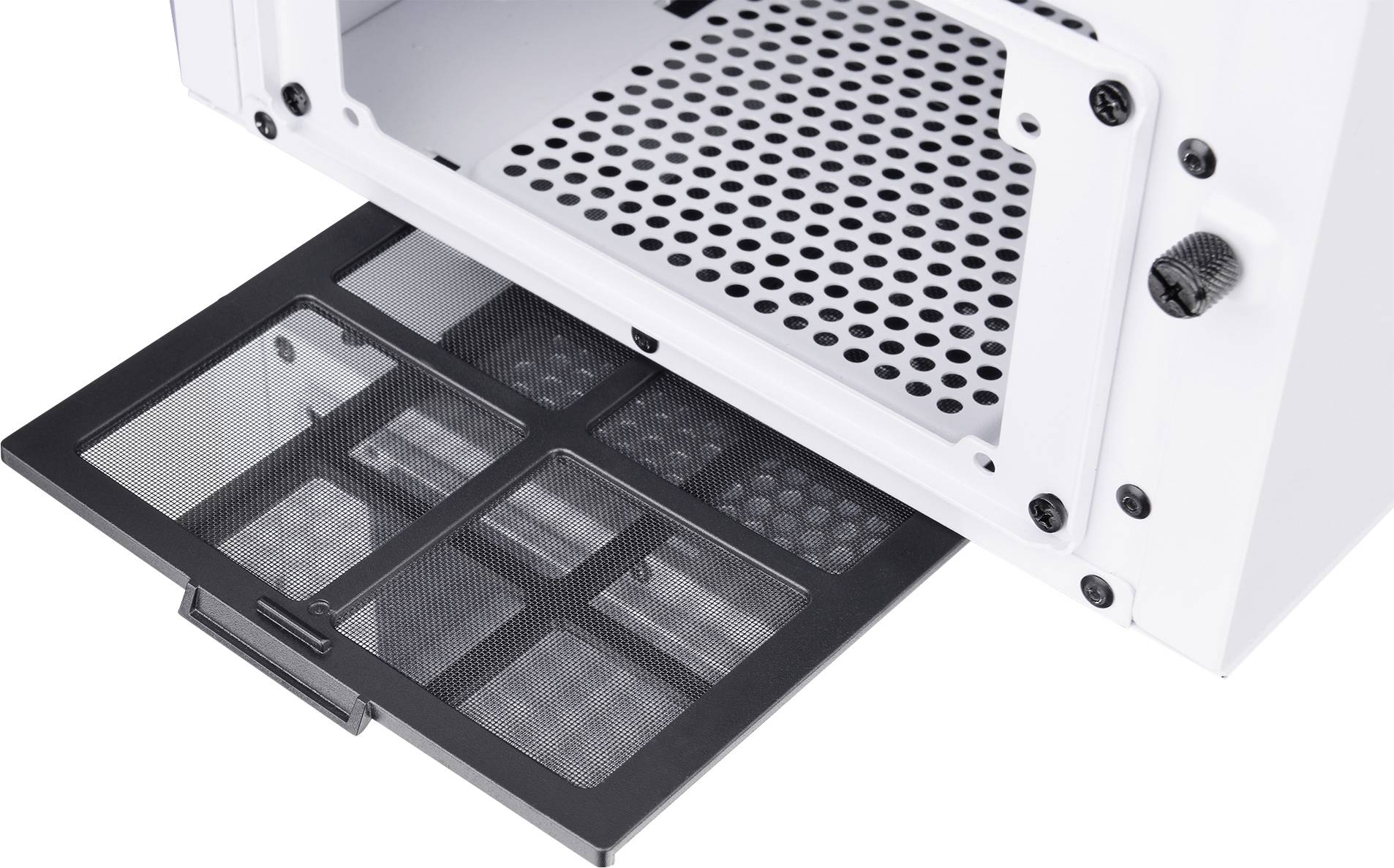 A white computer case with a perforated base reveals an extracted rectangular dust filter underneath.