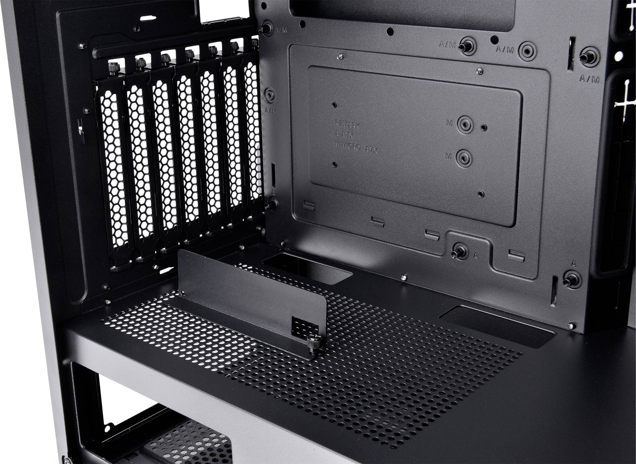 Internal view of a computer case with open ventilation slots and space for installing hardware components.