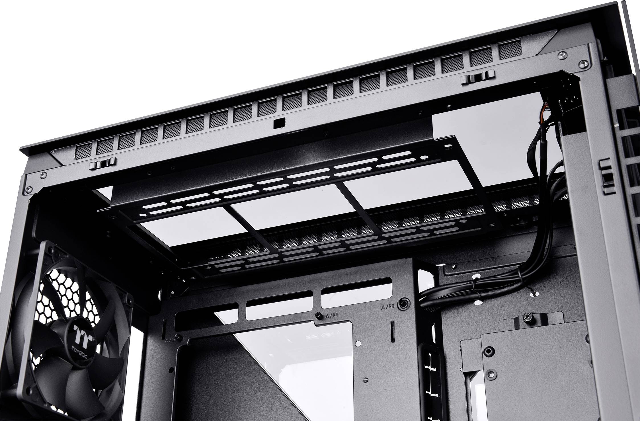 'Computer case without components, showing airy interior with mounted fan, cable management, and ventilation openings.'