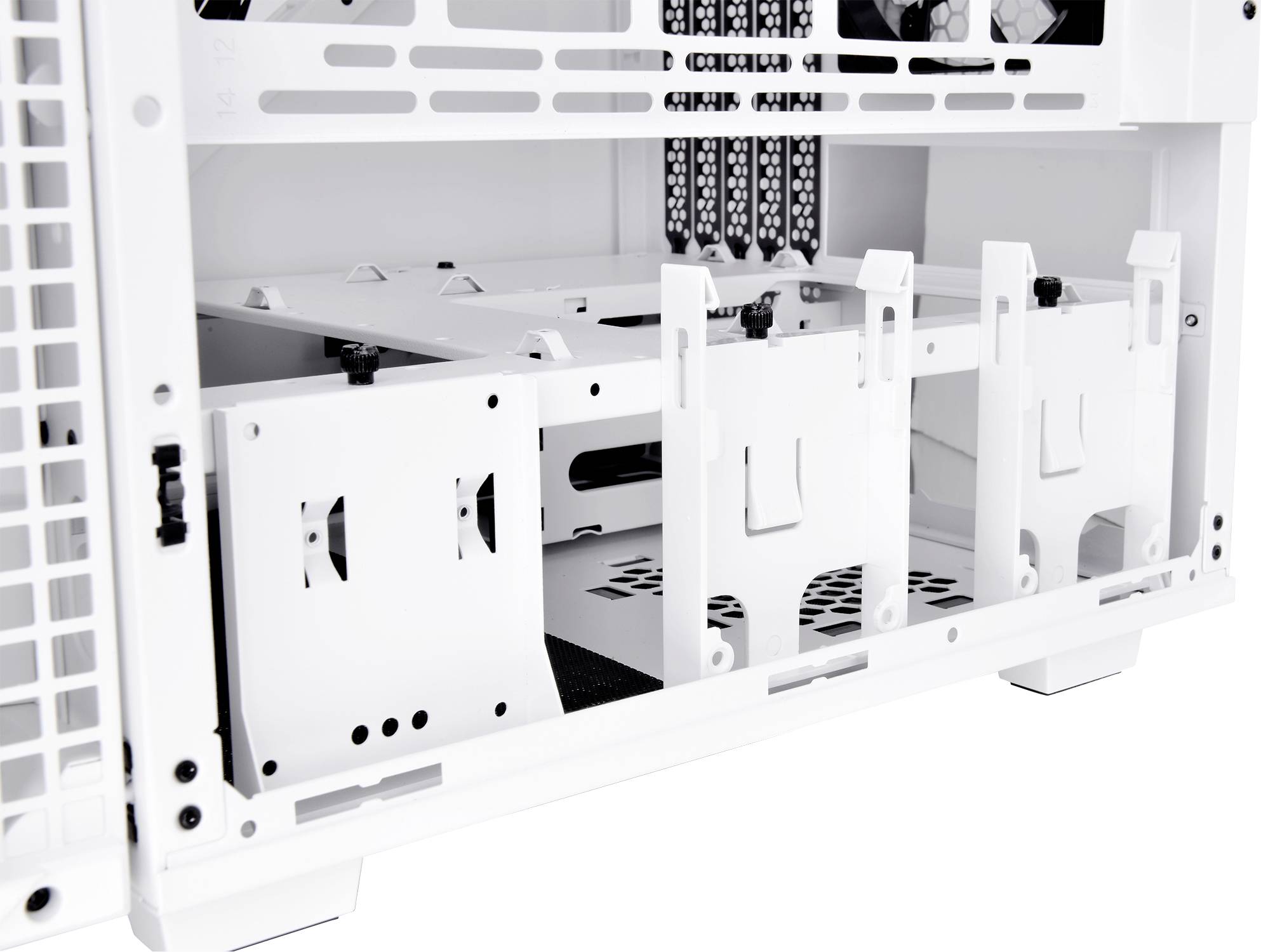 Interior view of a white computer chassis with multiple drive bays, potentially for hard disk drives or solid-state drives.